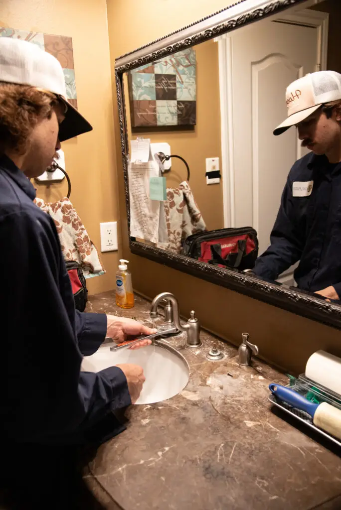 First Service plumber working on a sink